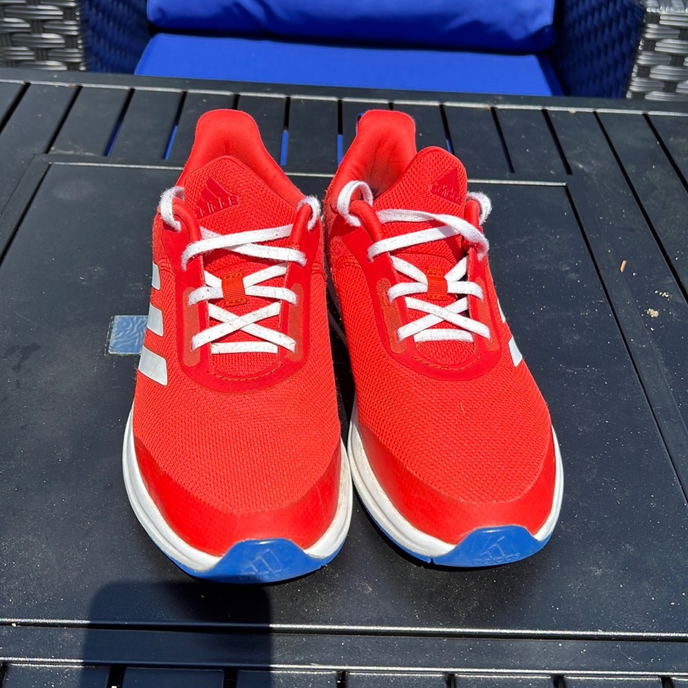 Red Adidas Men tennis shoes size 6.